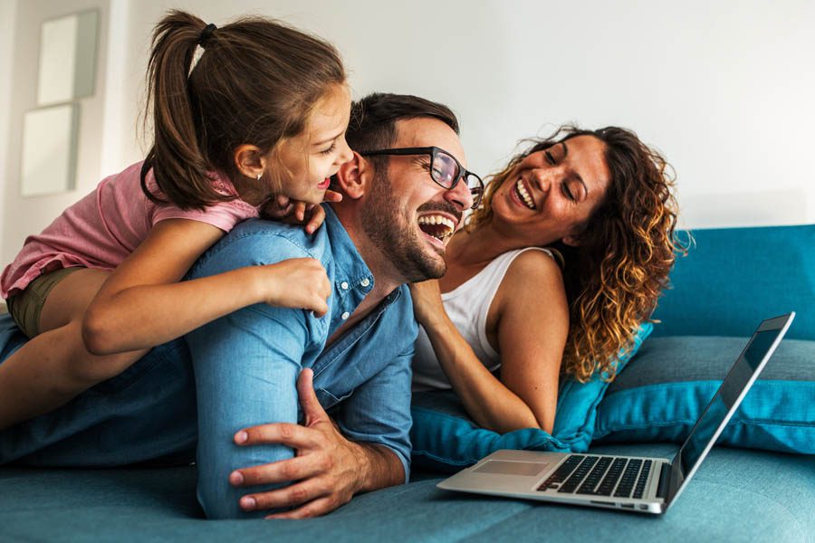 About Our Agency - Family Hanging Out in the Living Room